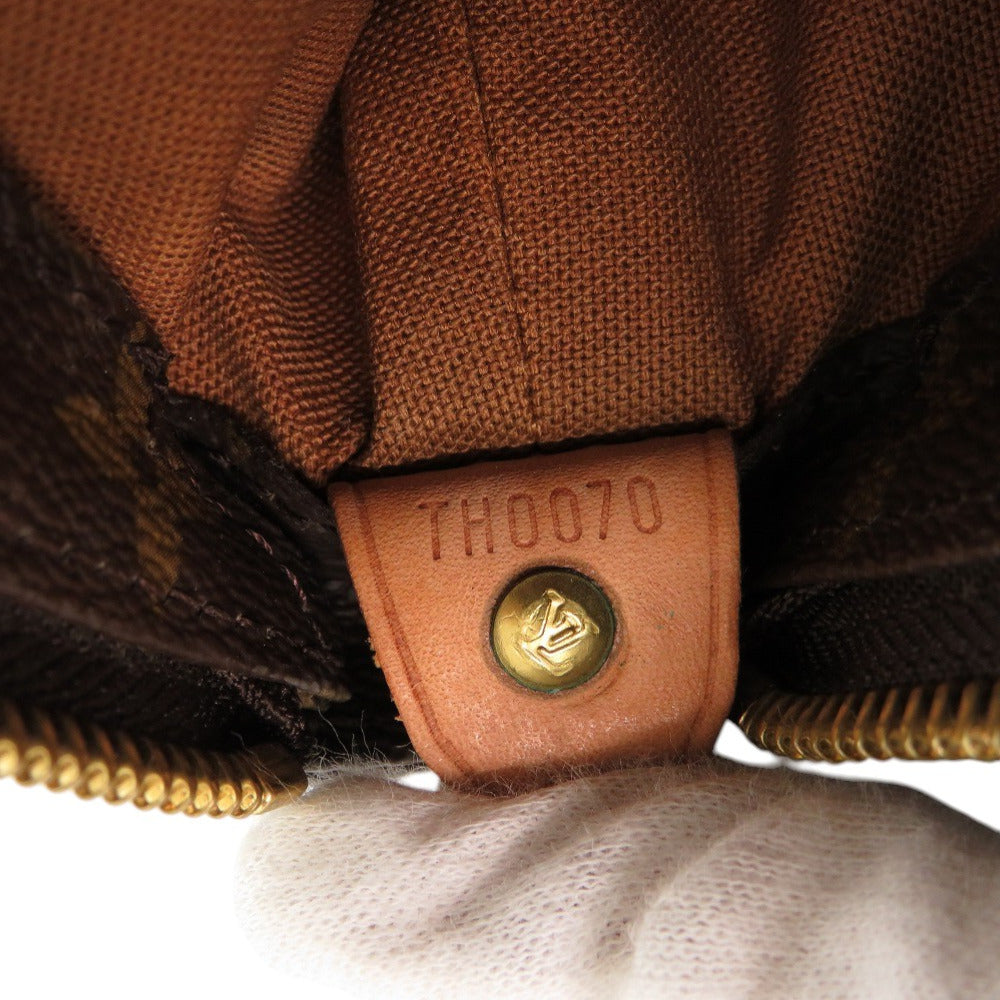 Close-up of a brown leather tag with 'TH0070' on a textured surface.