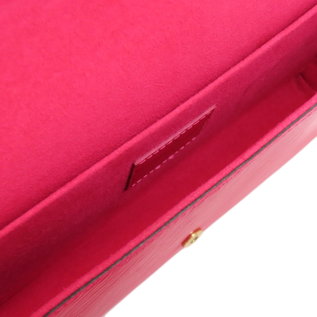 Close-up of a red box with a gold latch on a white background