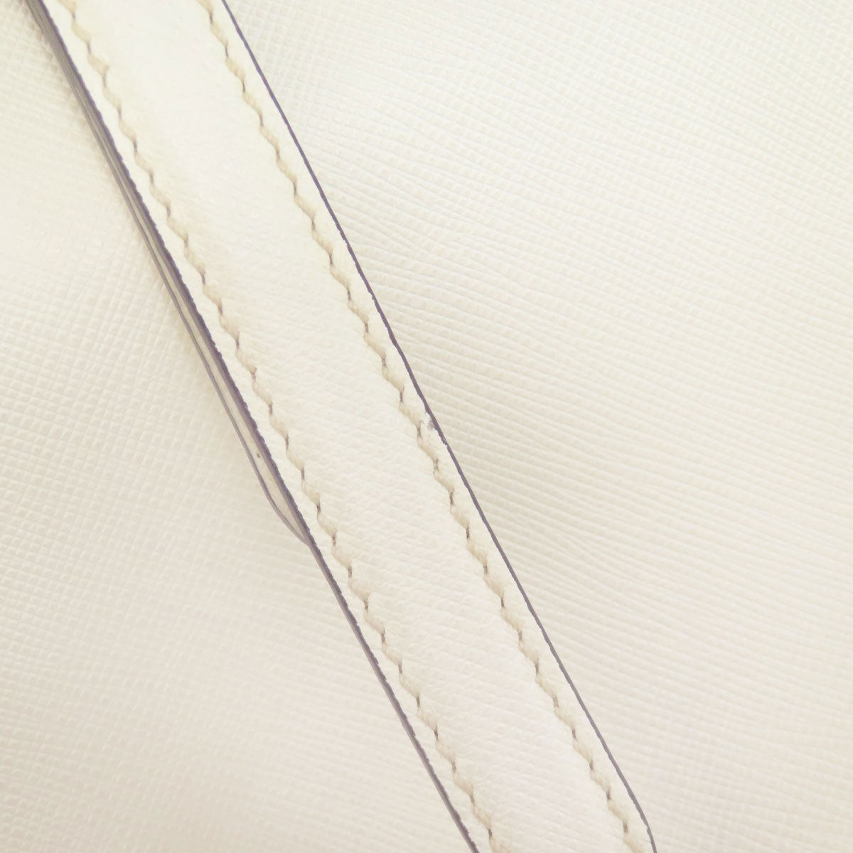 Close-up of a white fabric with visible stitching