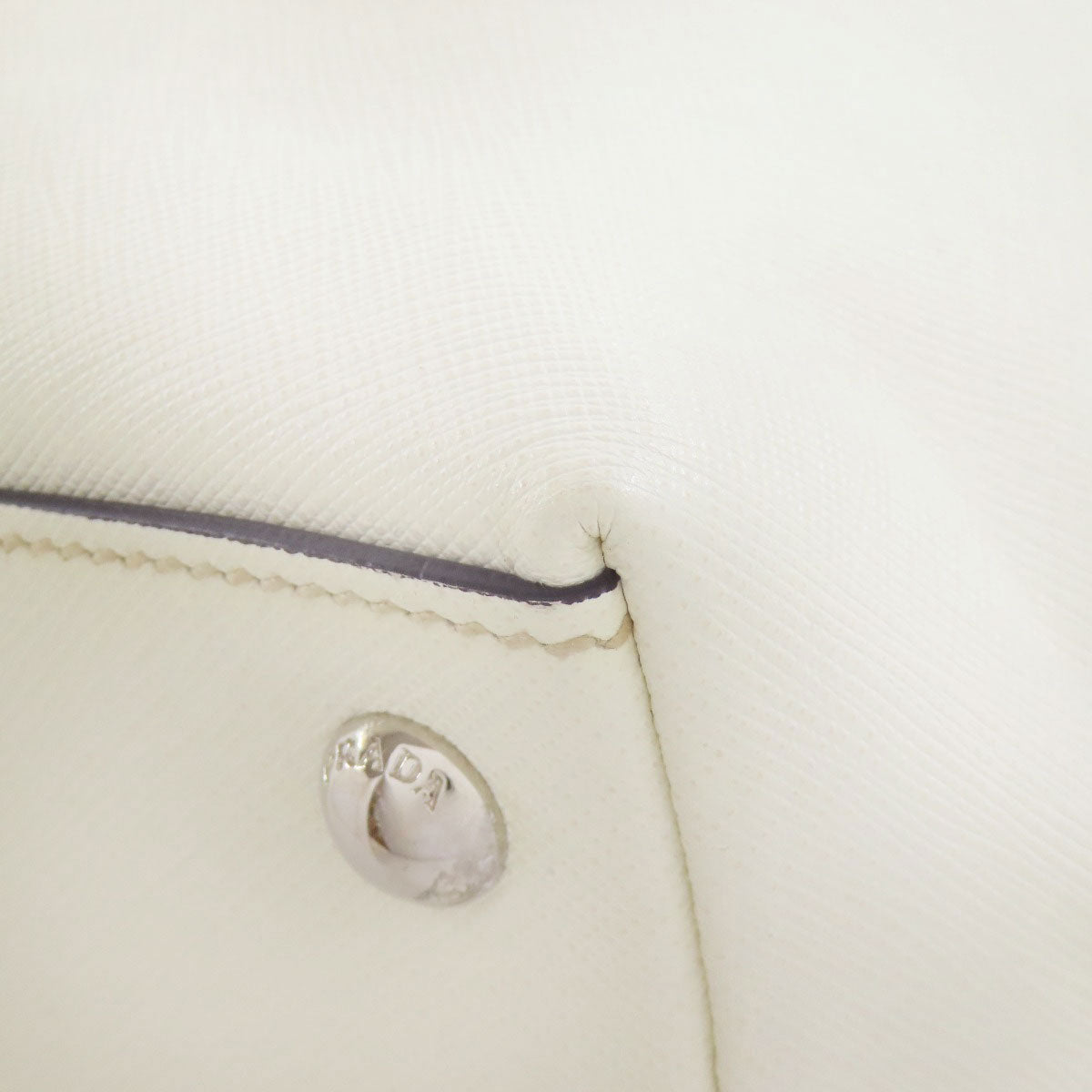 Close-up of a beige fabric with a brand logo on a white background