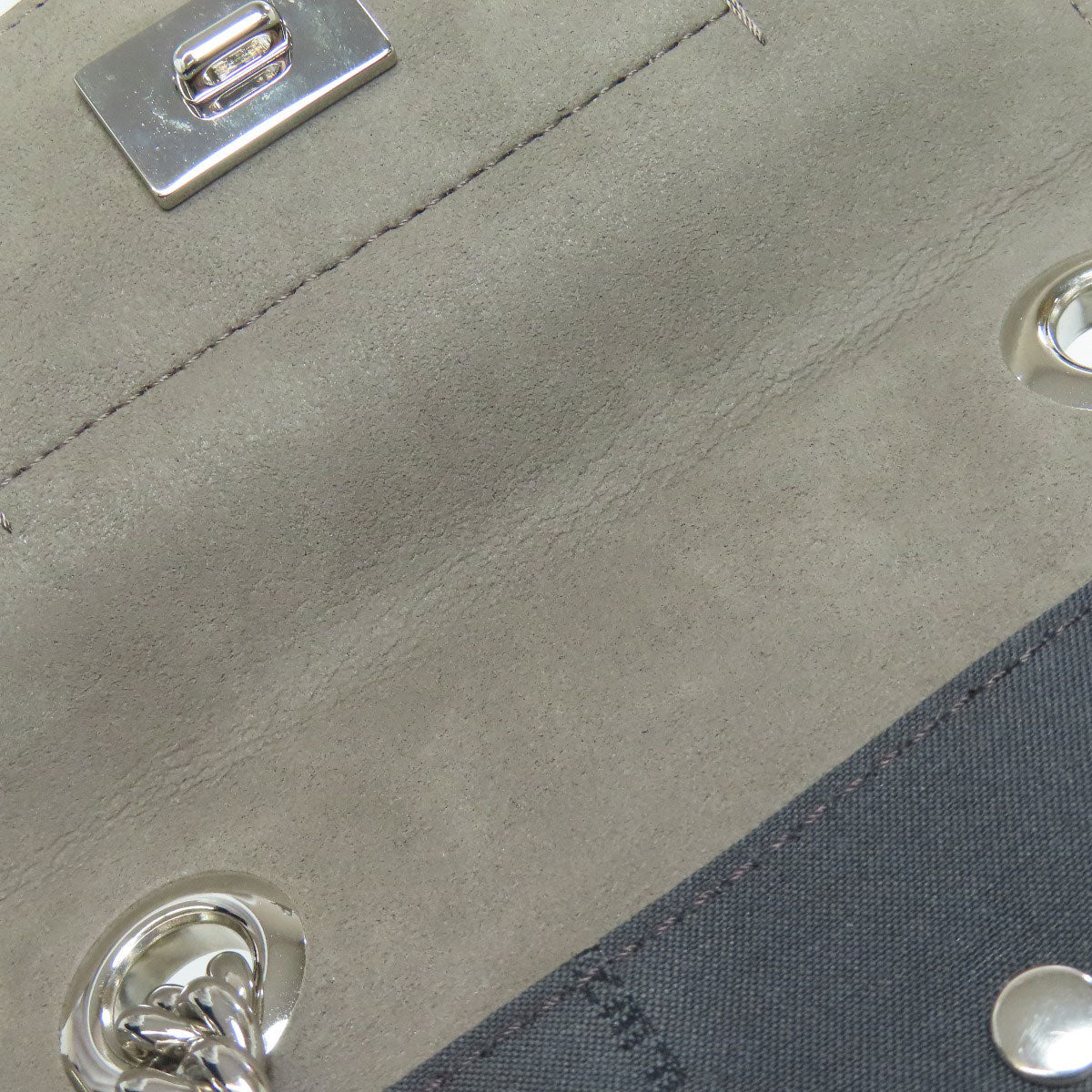 Close-up of a textured surface with metallic buttons