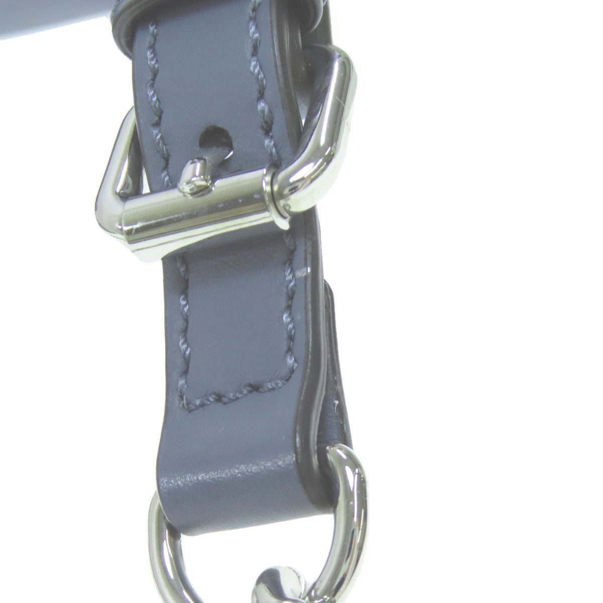 Gray leather strap with silver buckle on a white background