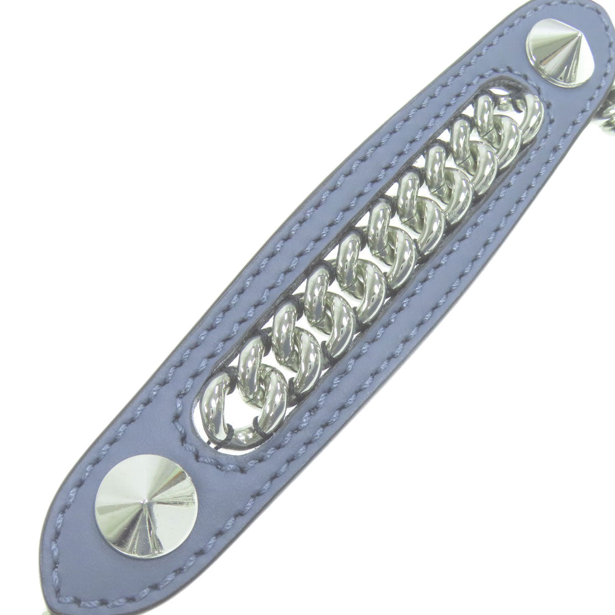 Blue leather strap with silver chain and studs on a white background