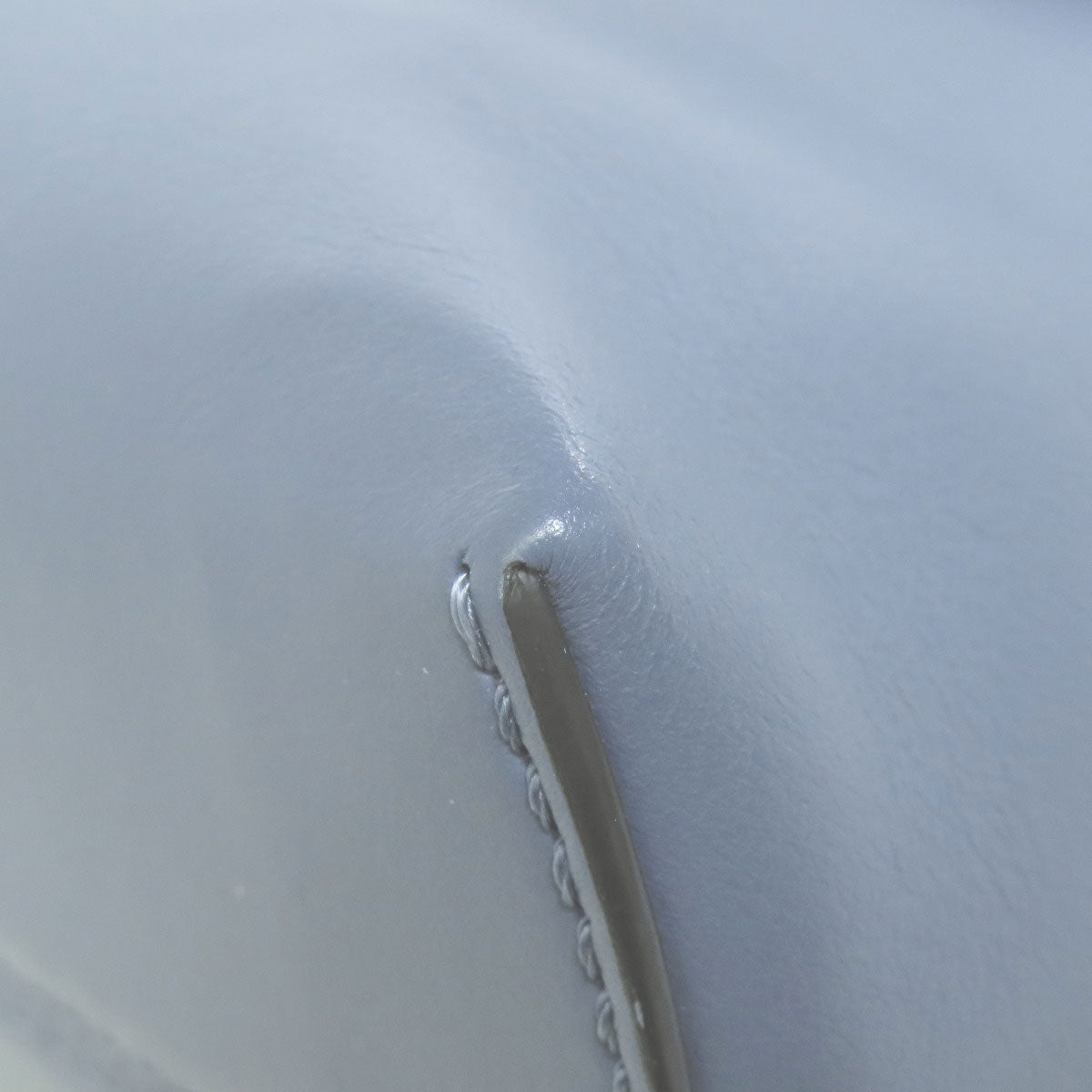 Close-up of a metal handle on a white surface