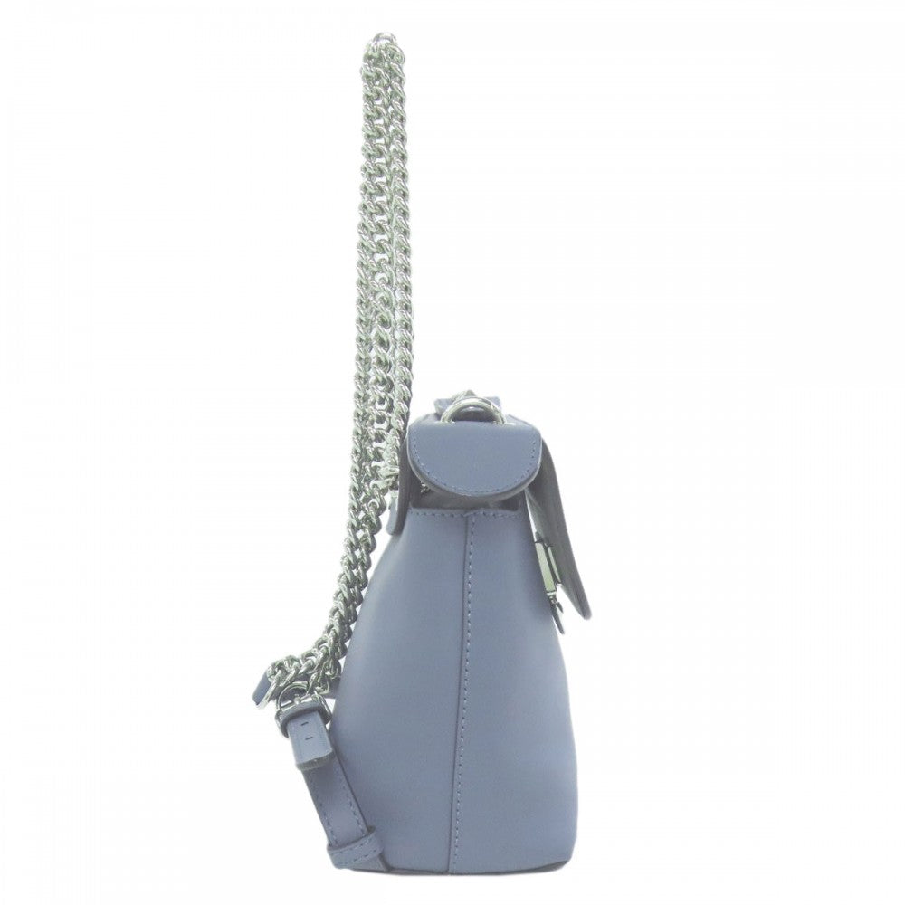 Small blue handbag with a chain strap on a white background
