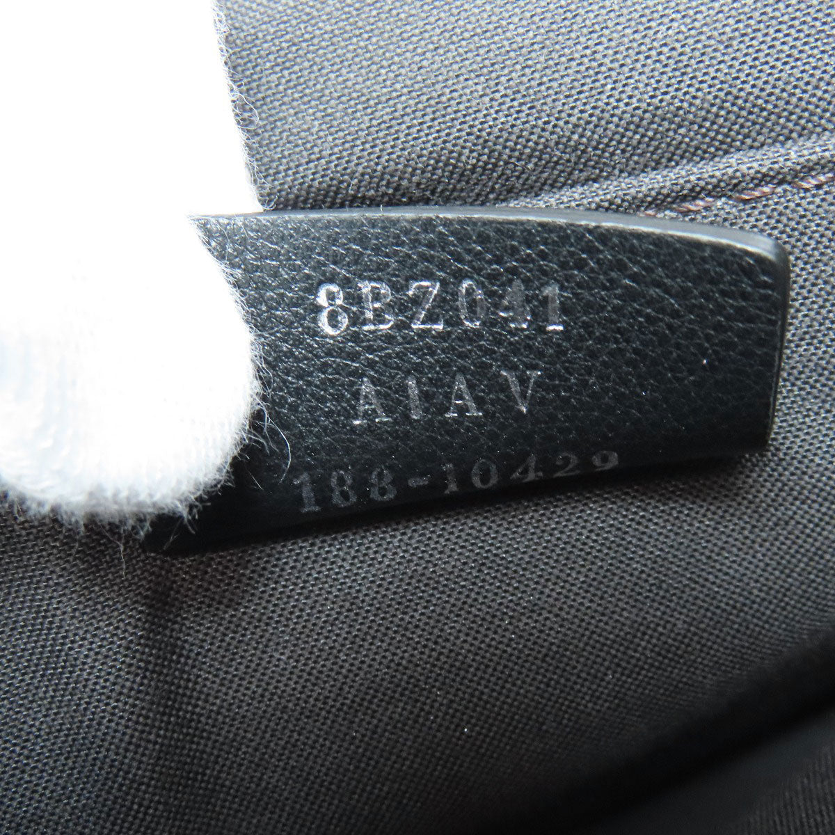 Close-up of a label on a textured surface with text and numbers.