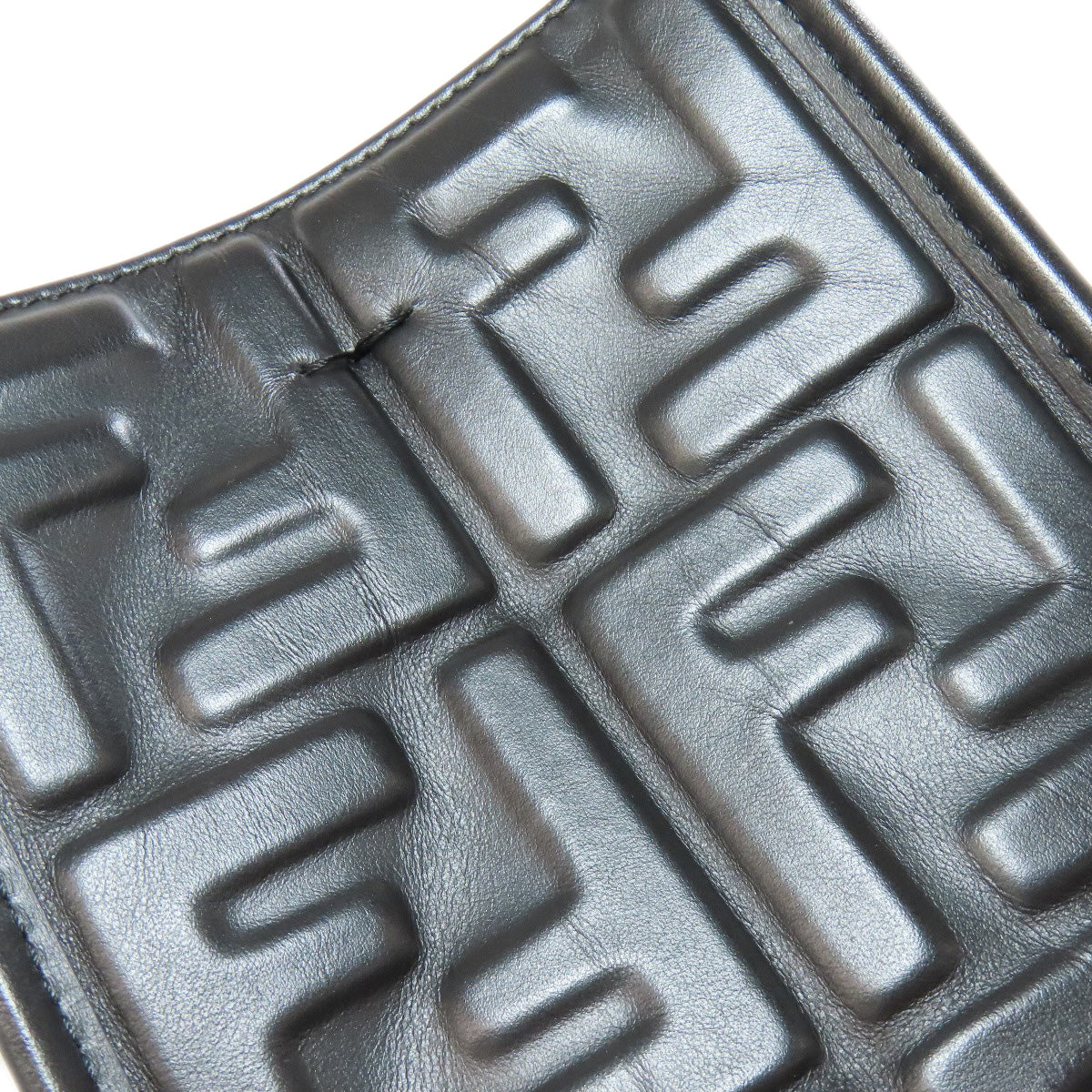 Close-up of a textured black surface with geometric patterns