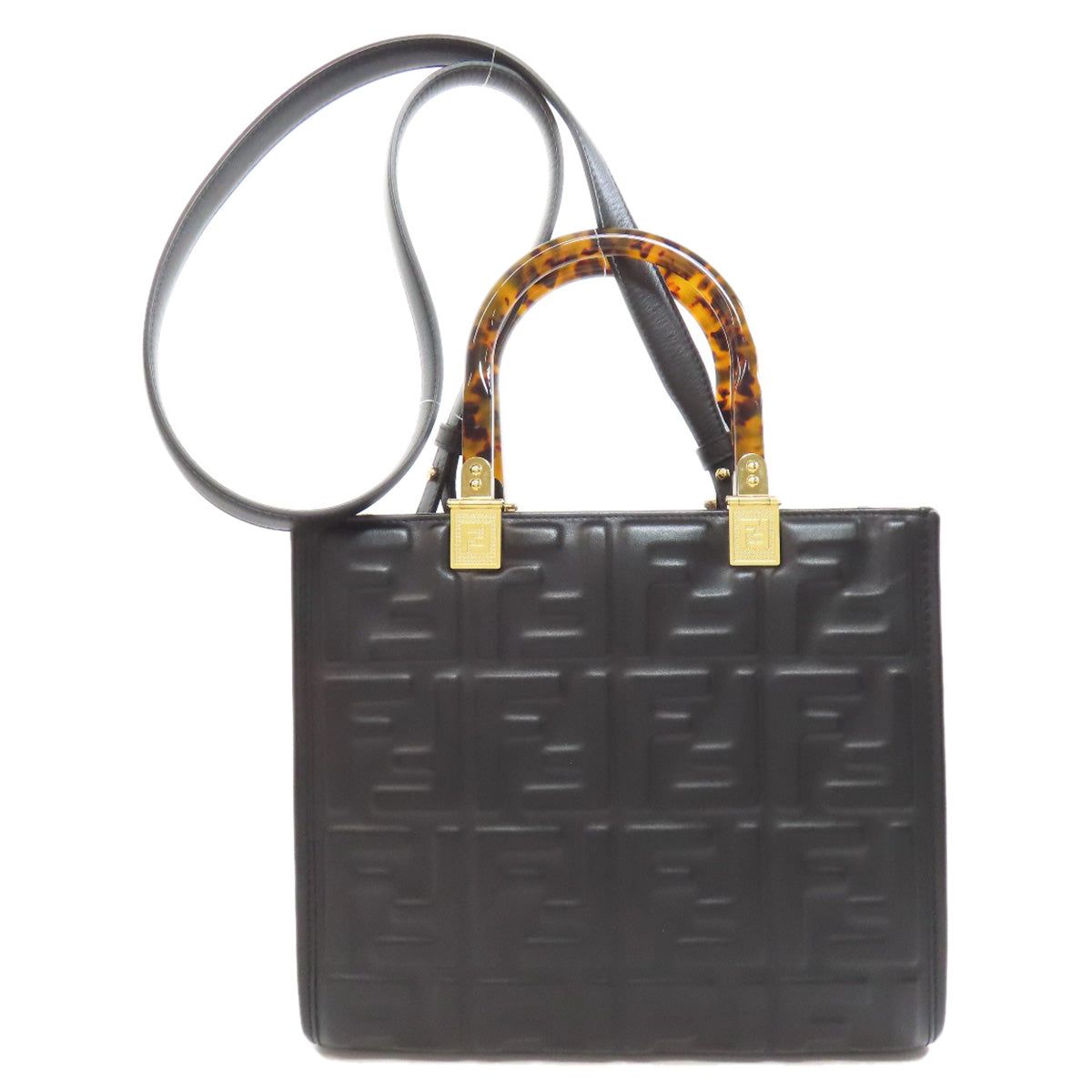 Black handbag with a tortoiseshell handle on a white background