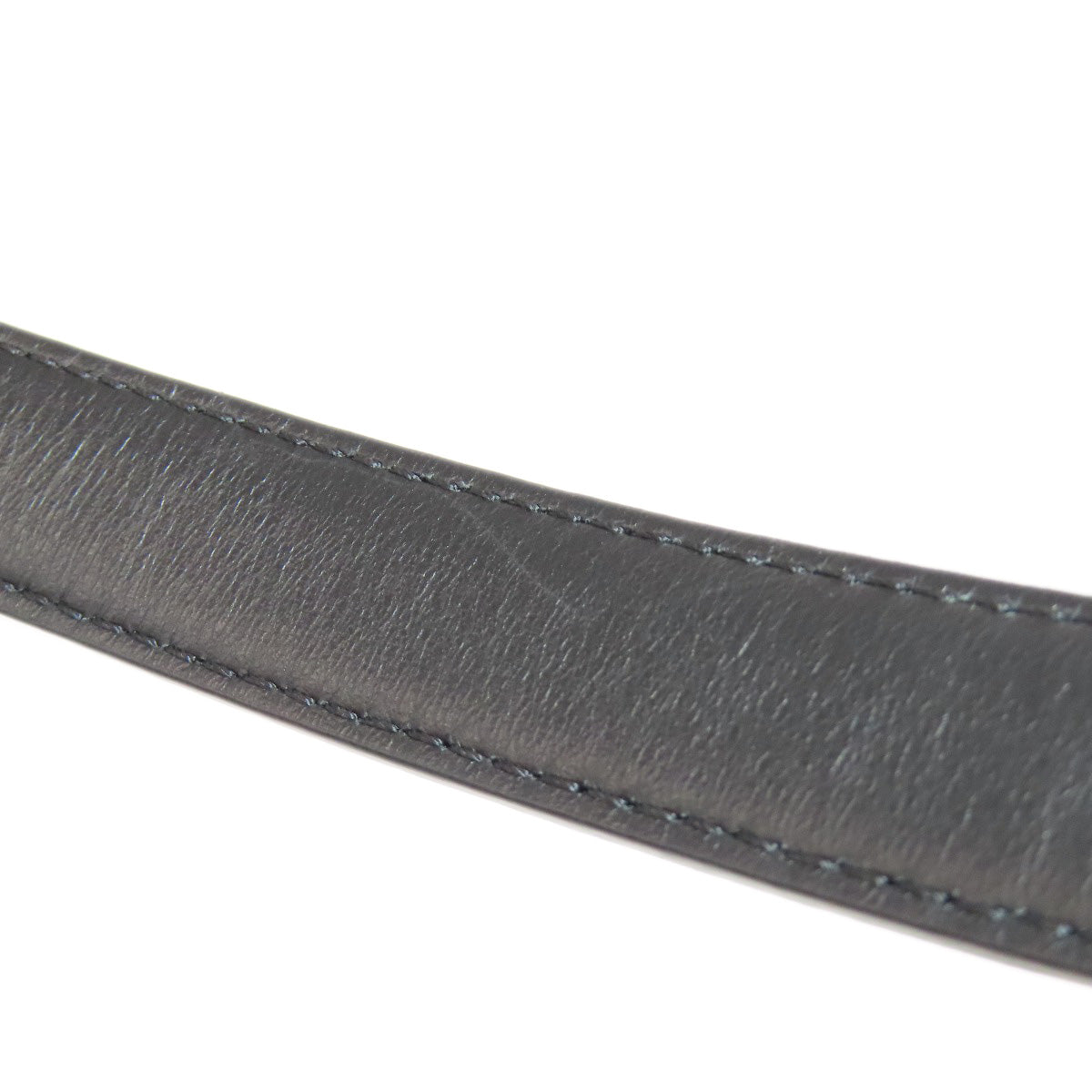 Close-up of a gray leather belt strap on a white background