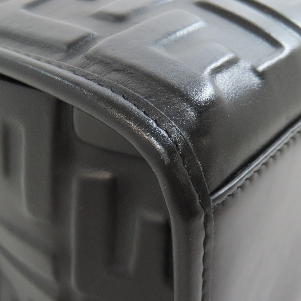 Close-up of a textured black suitcase corner