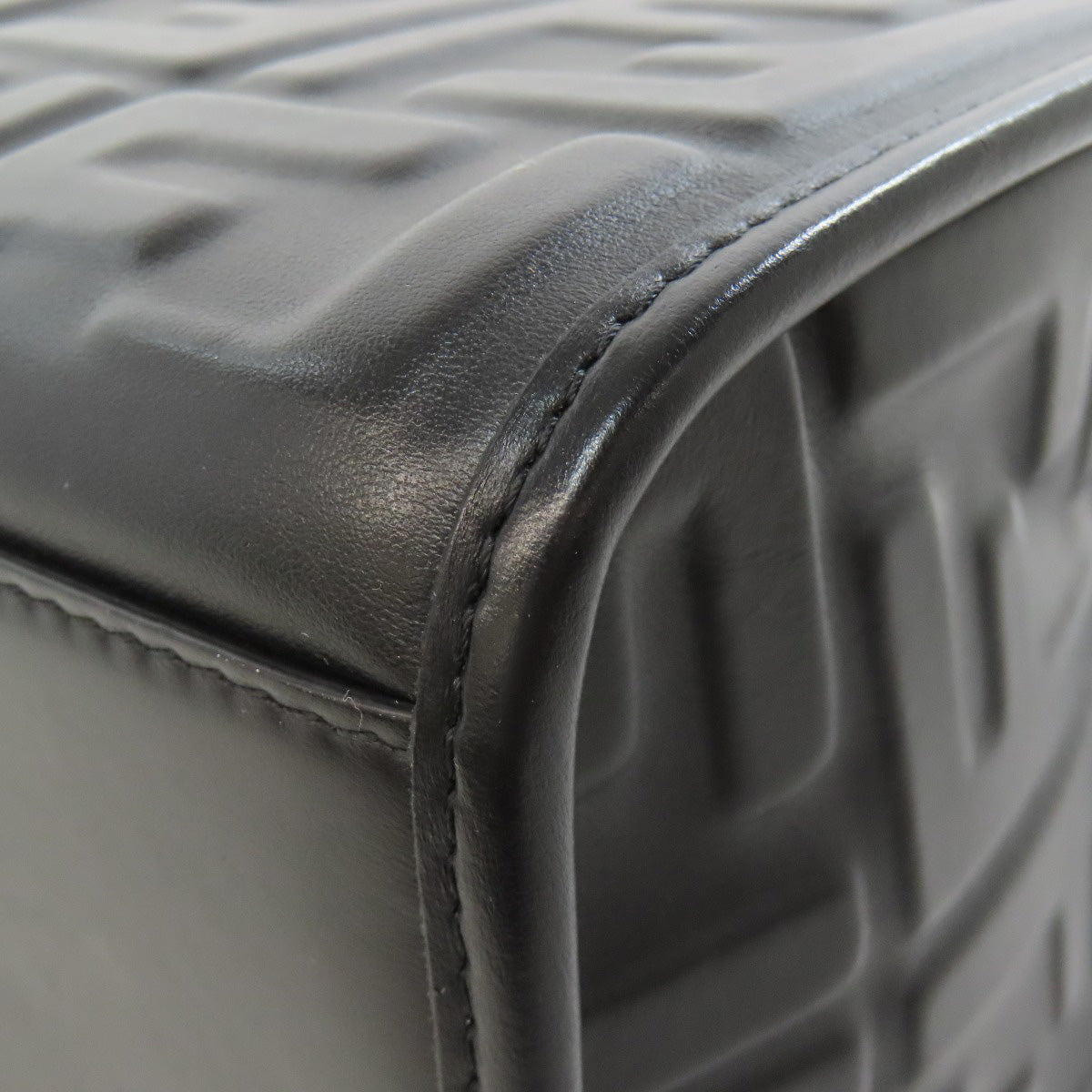 Close-up of a textured gray leather product with a focus on the corner.