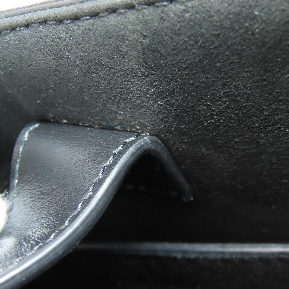 Close-up of black leather surface with stitching detail