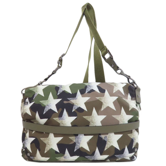 Bag with star pattern and green strap on a white background