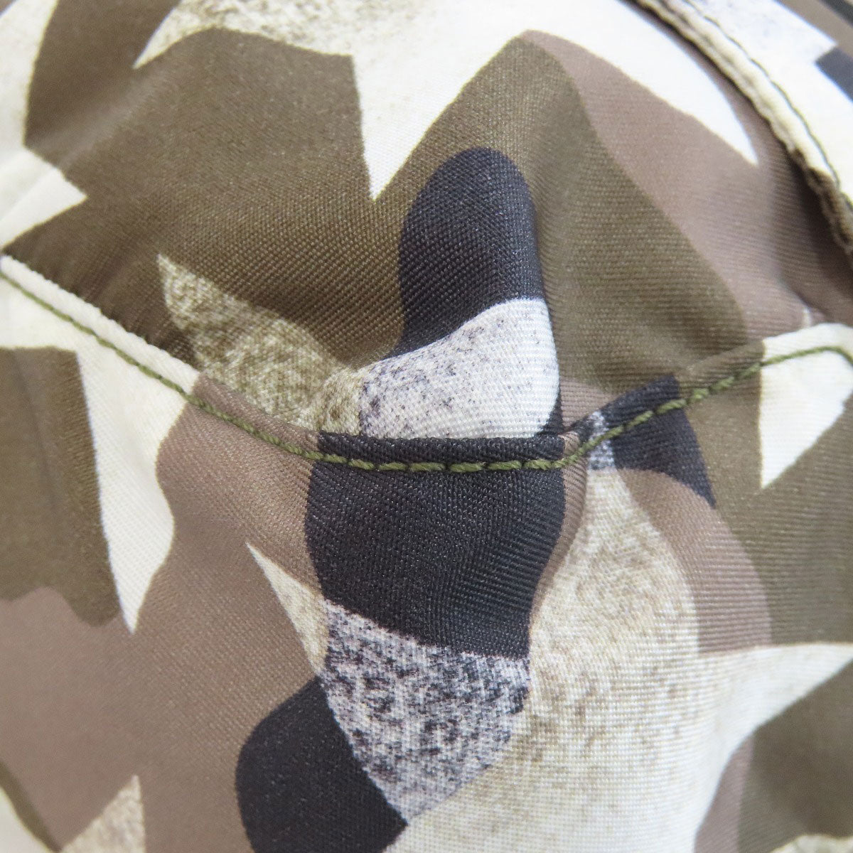 Close-up of camouflage fabric with stitching detail