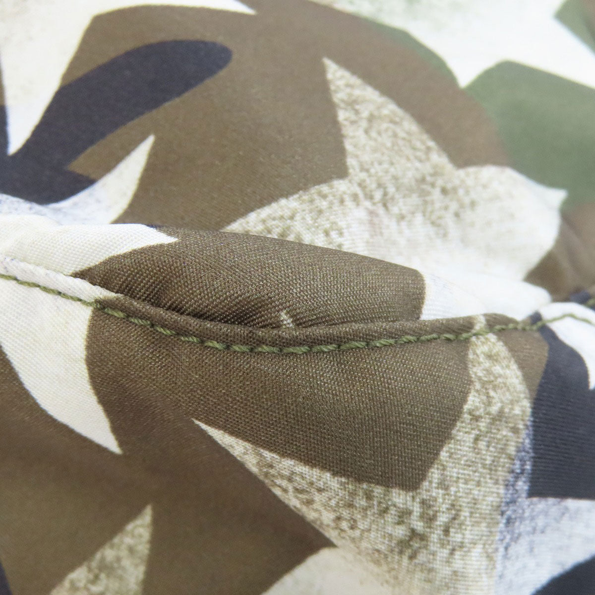 Close-up of camouflage fabric with stitching detail