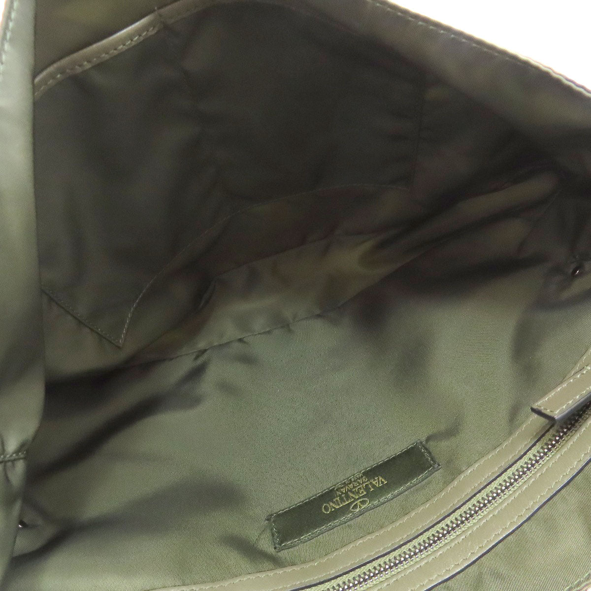Close-up of a green bag with a visible brand label.