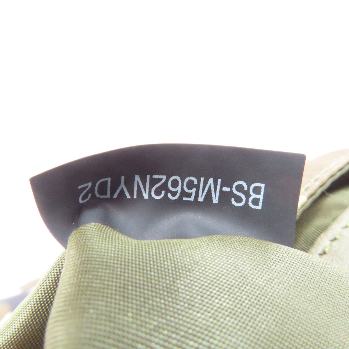 Close-up of a green fabric with a label on a white background