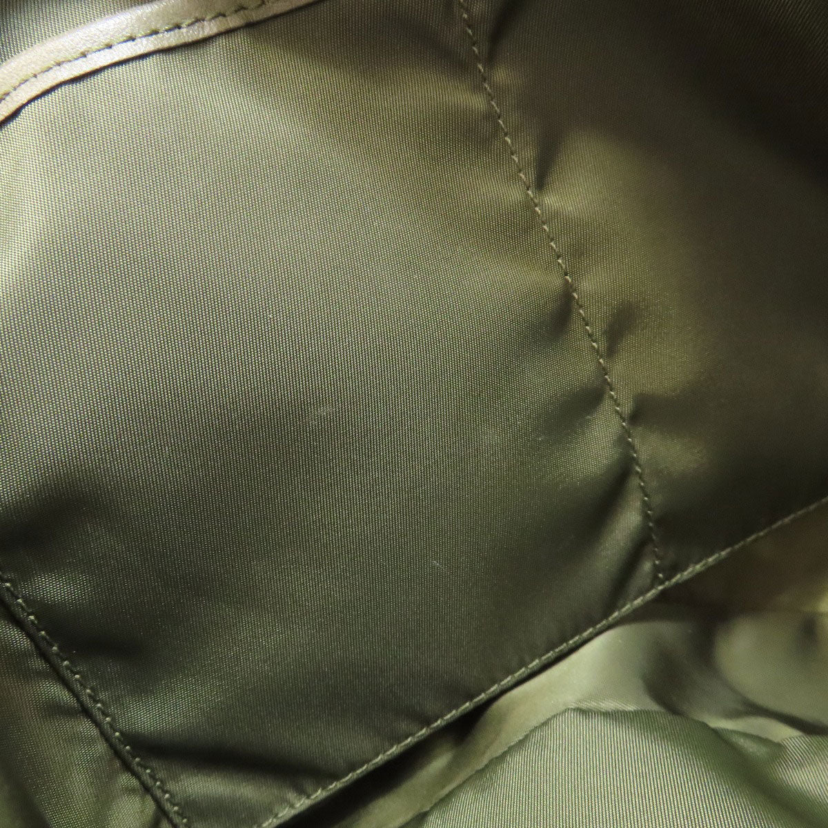 Close-up of a green jacket with stitching detail