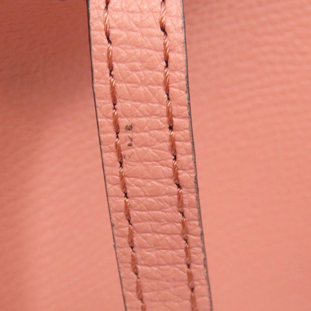 Close-up of pink leather with visible stitching