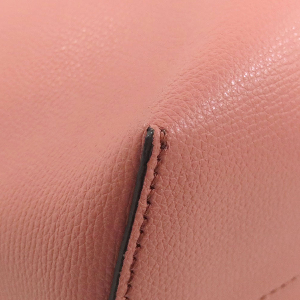 Close-up of pink leather with a visible seam