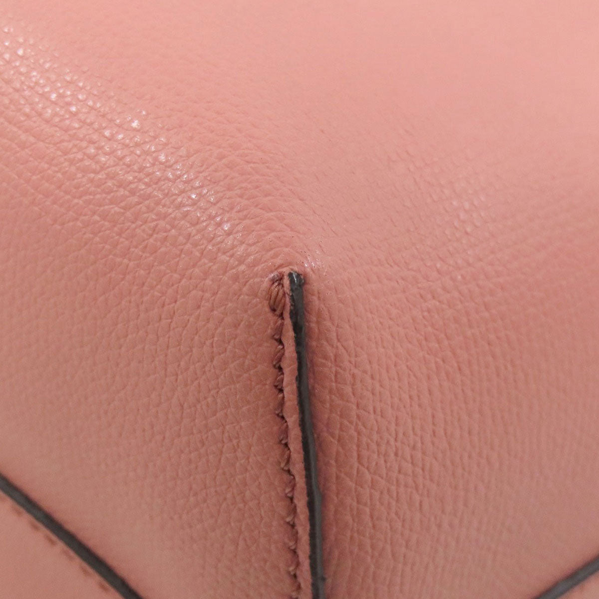 Close-up of a brown leather bag with visible stitching