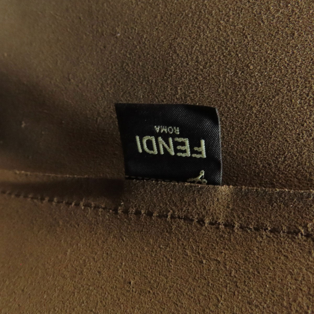 Fendi label on a brown fabric background