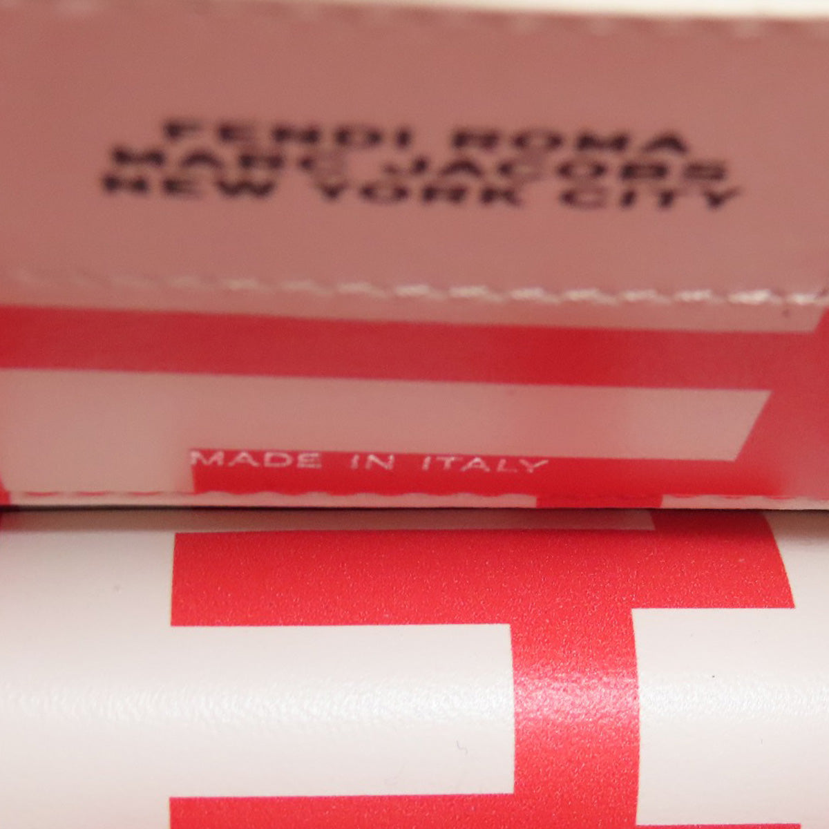 Red and white box with 'Fendi Roma' and 'Marc Jacobs' branding, featuring the letter 'F'.