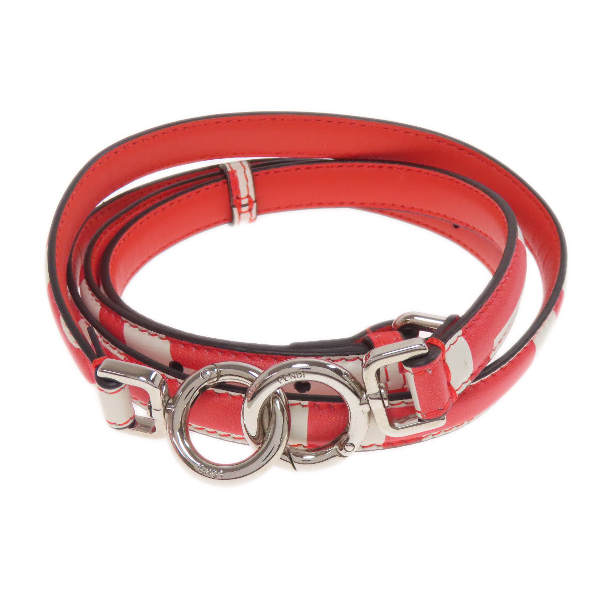 Red leather belt with silver hardware on a white background