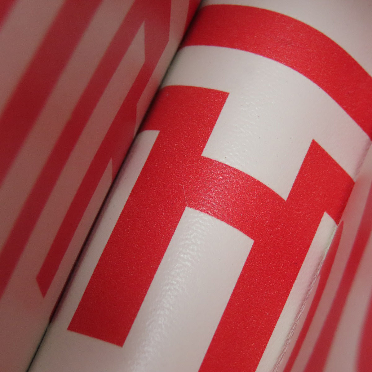 Close-up of a red and white object with a prominent 'H' logo.