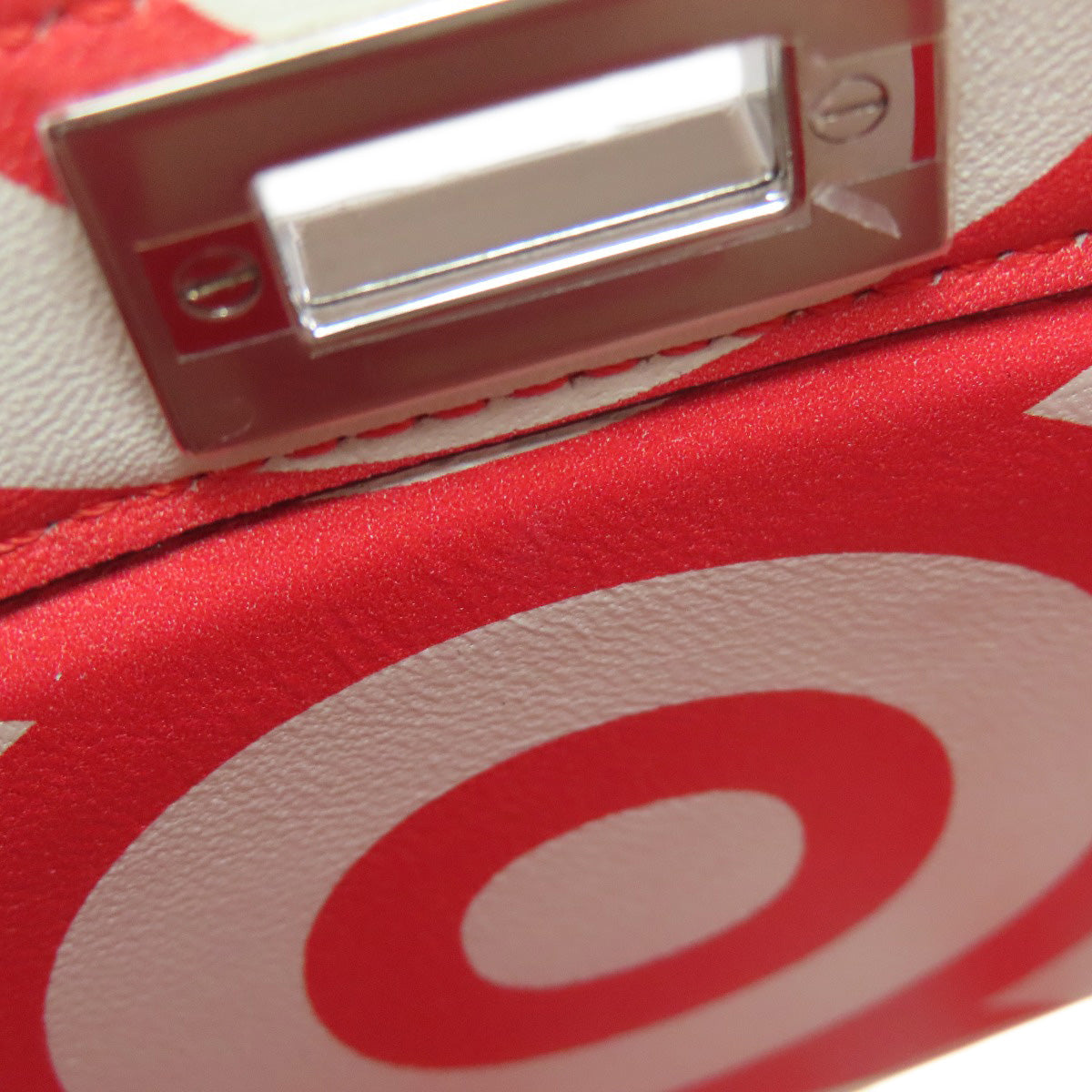 Close-up of a red and white product with a metallic label