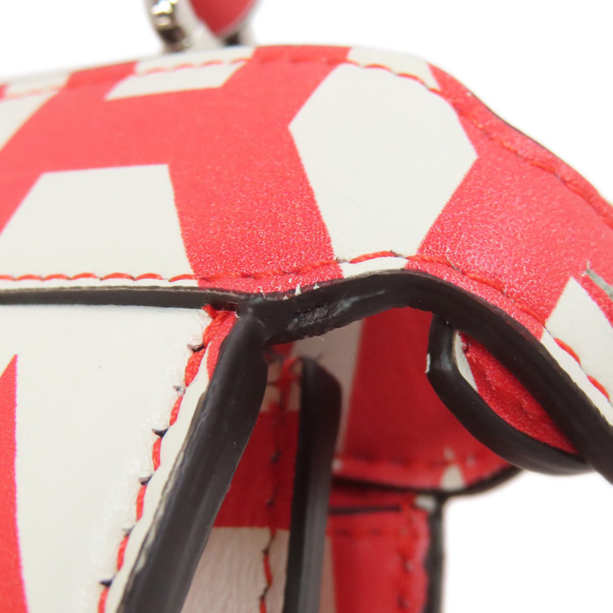 Close-up of a red and white patterned product with black accents