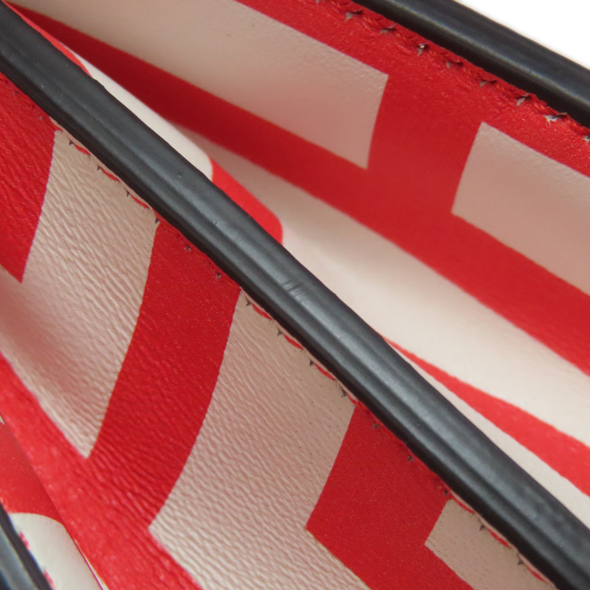 Close-up of a red and beige textured surface with black accents