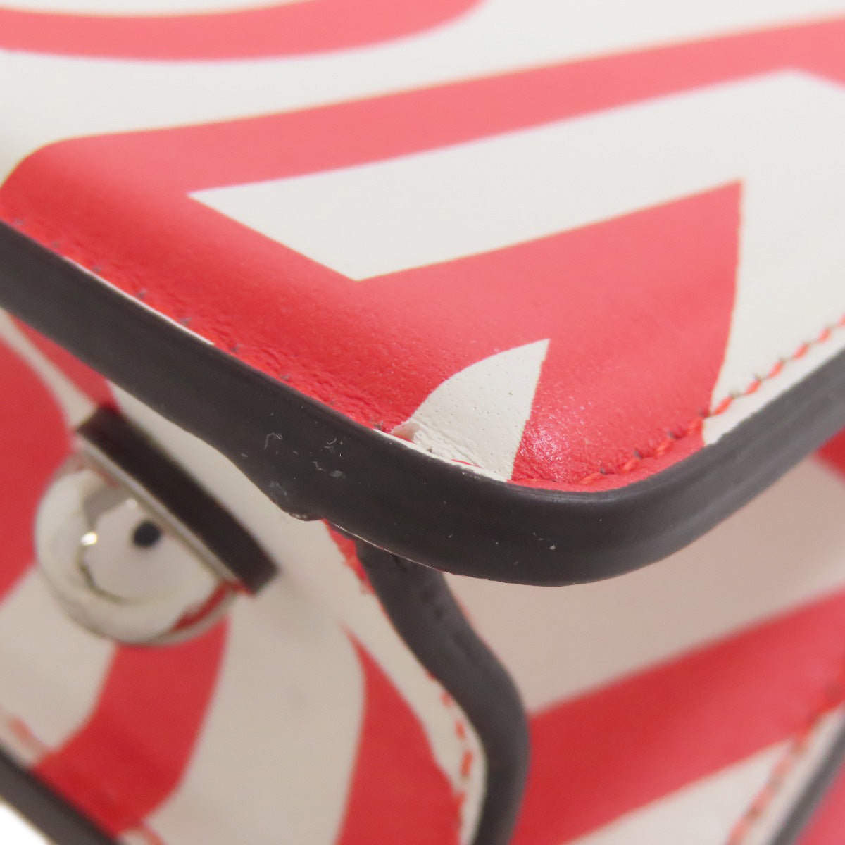 Close-up of a red and white patterned product with black accents