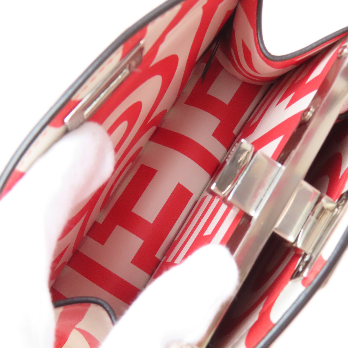 Close-up of a red and white patterned bag with a silver clasp.