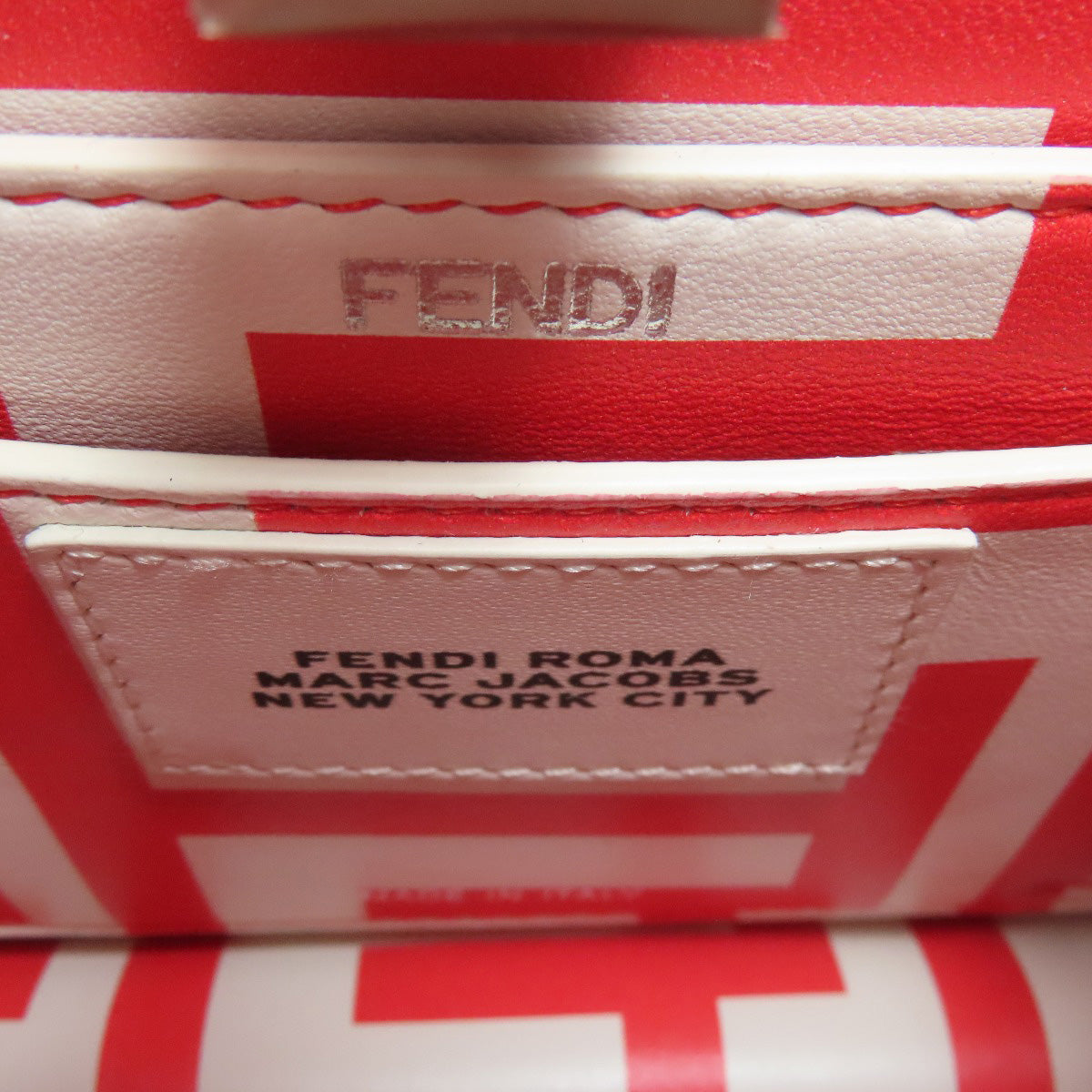 Close-up of a red and white Fendi product with branding details.