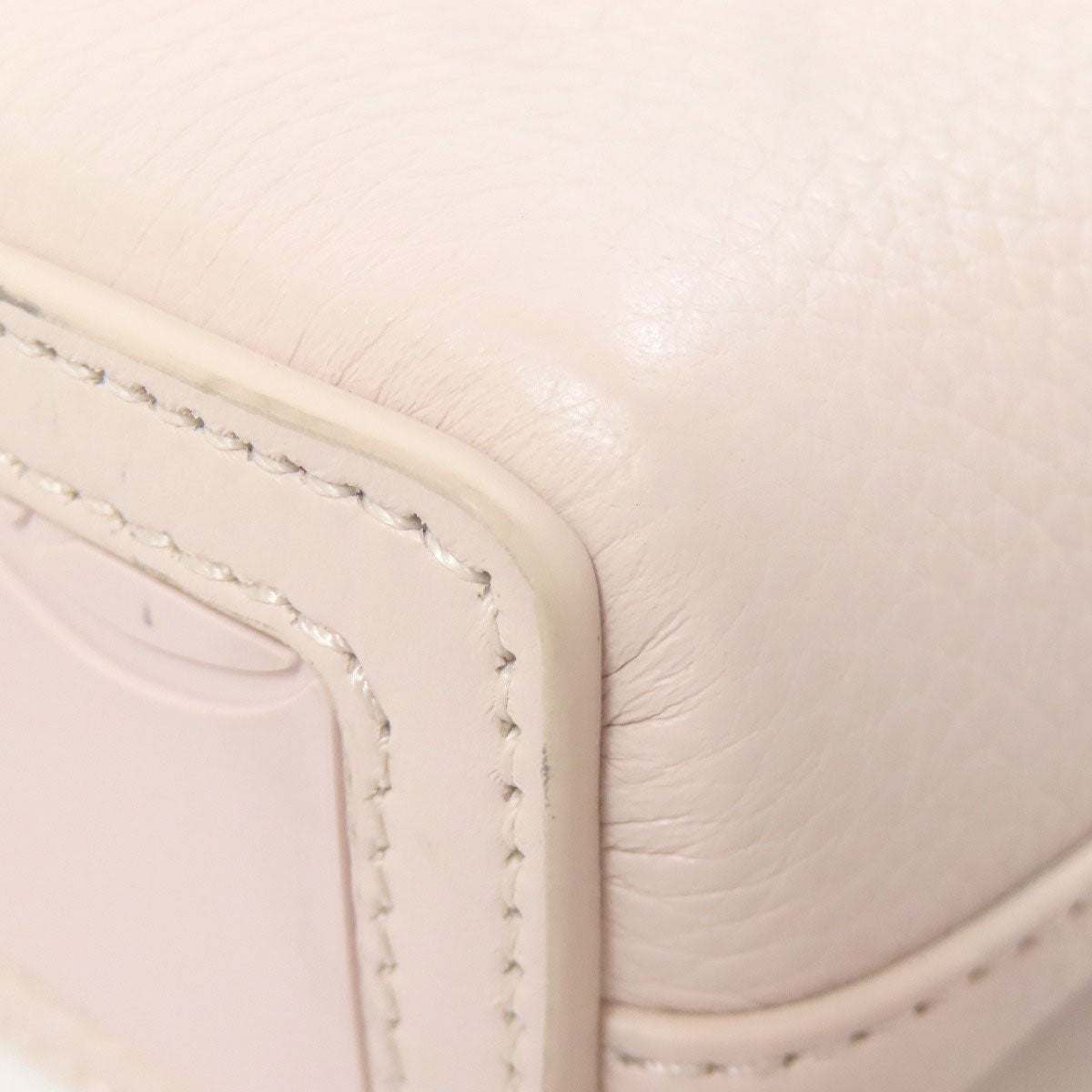 Close-up of a beige leather product with stitching detail