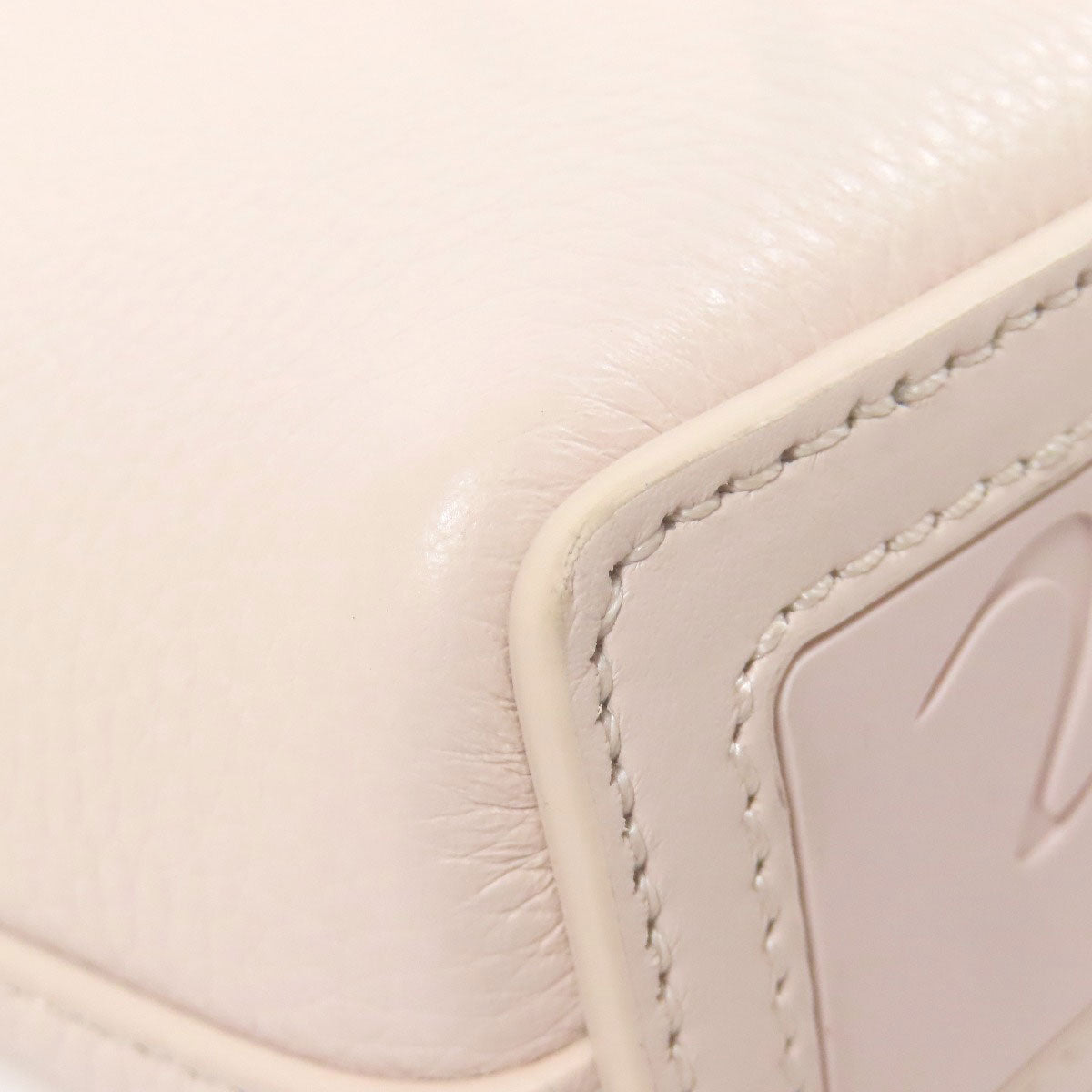 Close-up of a beige leather product with stitching detail