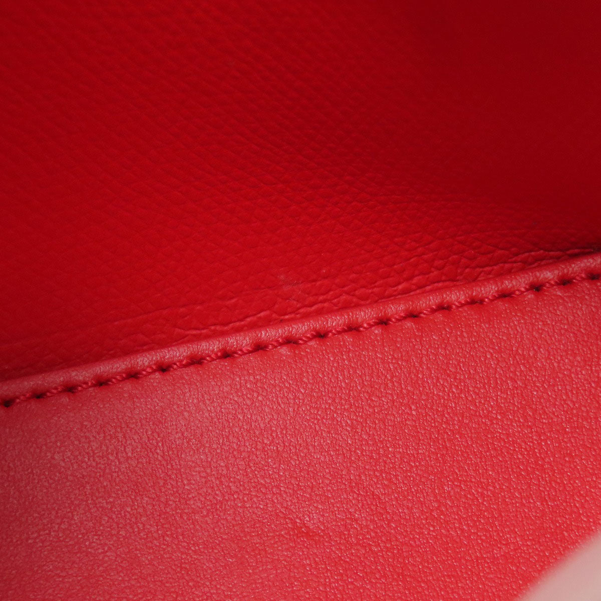 Close-up of red leather with visible stitching