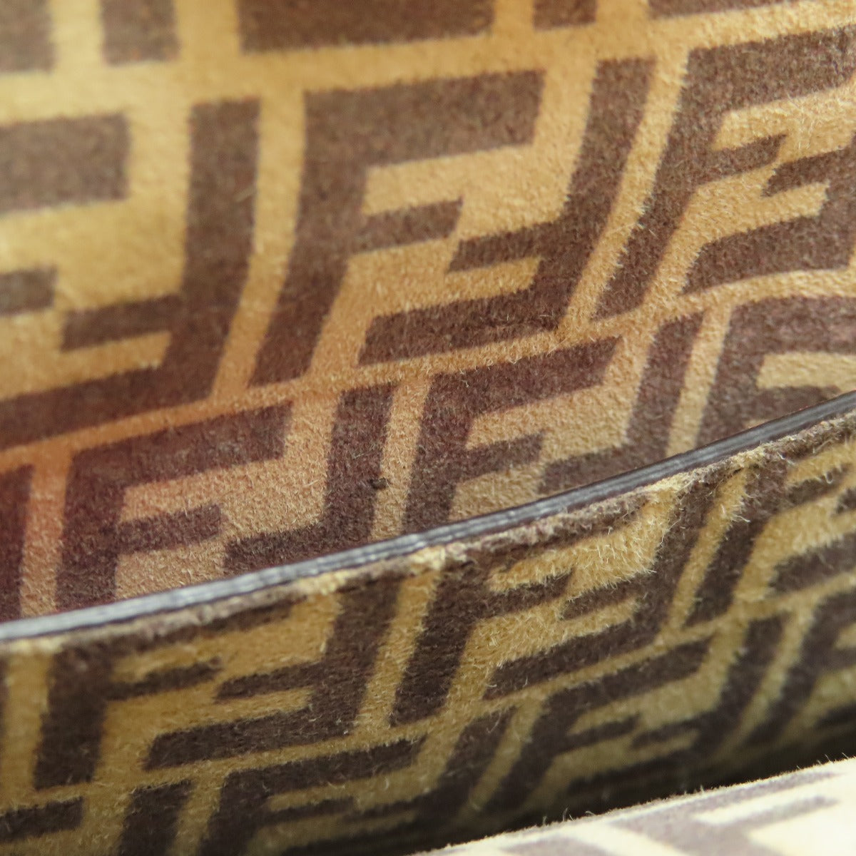 Close-up of a patterned surface with 'F' logo design