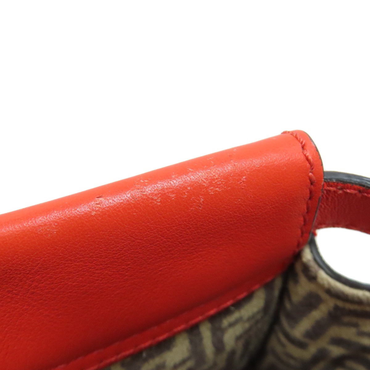 Close-up of a red leather handle with a white background