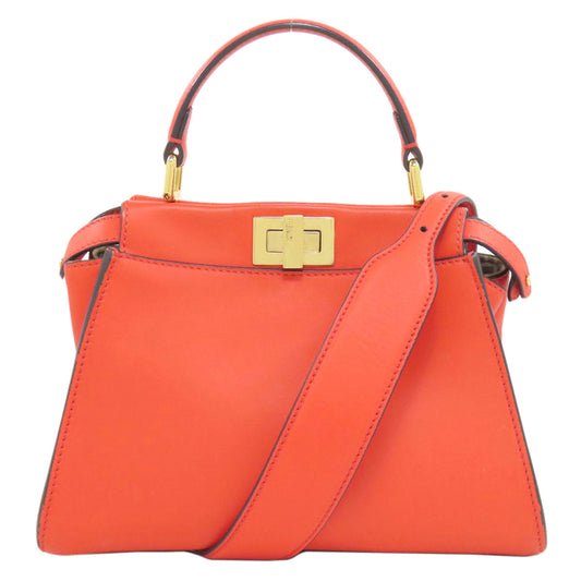 Orange handbag with a gold clasp on a white background