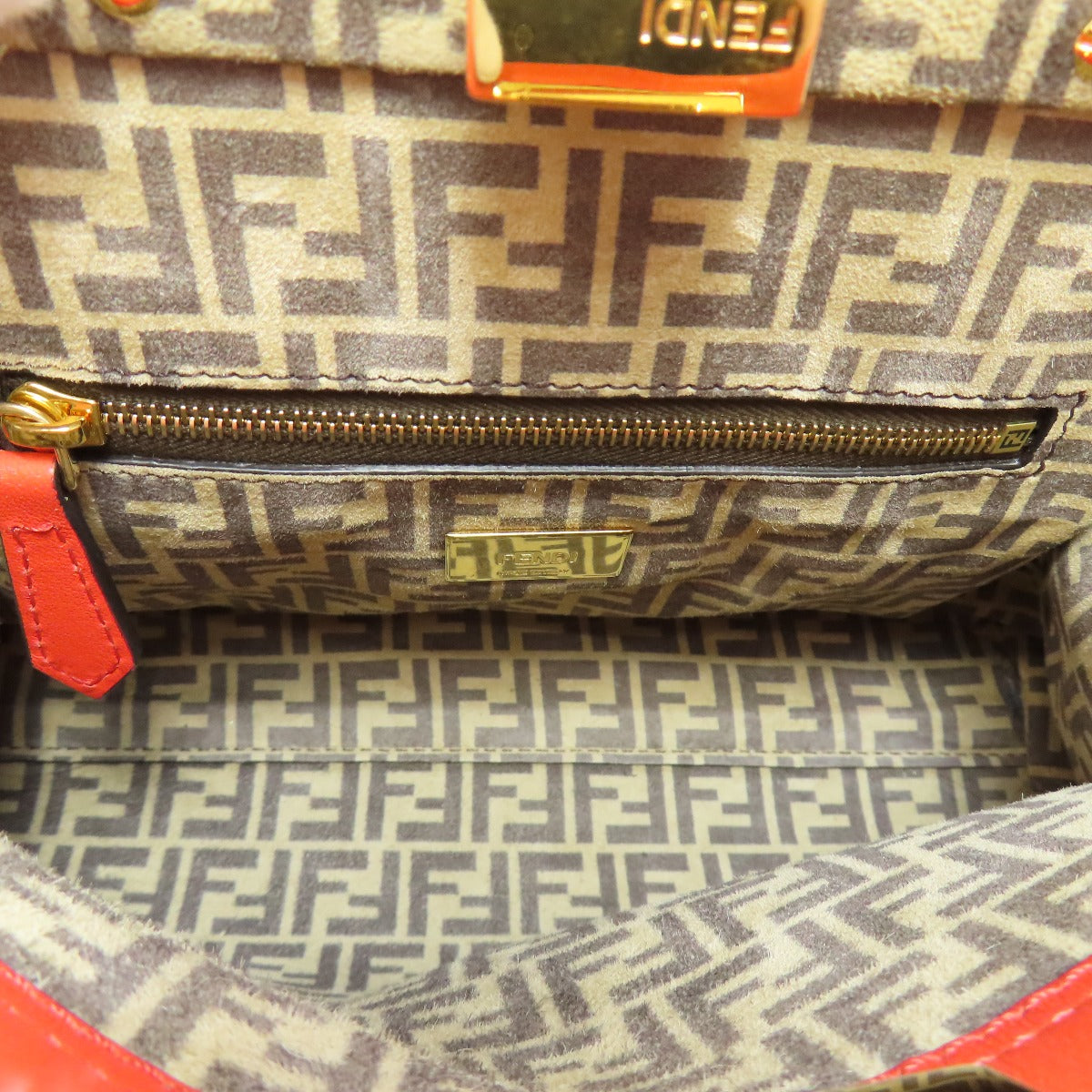 Close-up of a patterned handbag with visible brand logo.