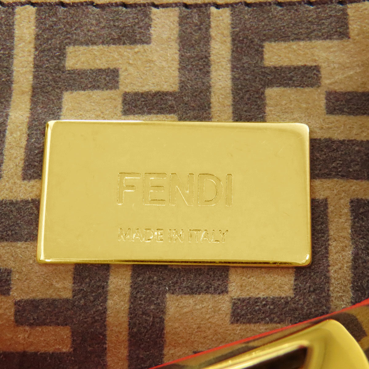 Gold Fendi logo on a patterned background