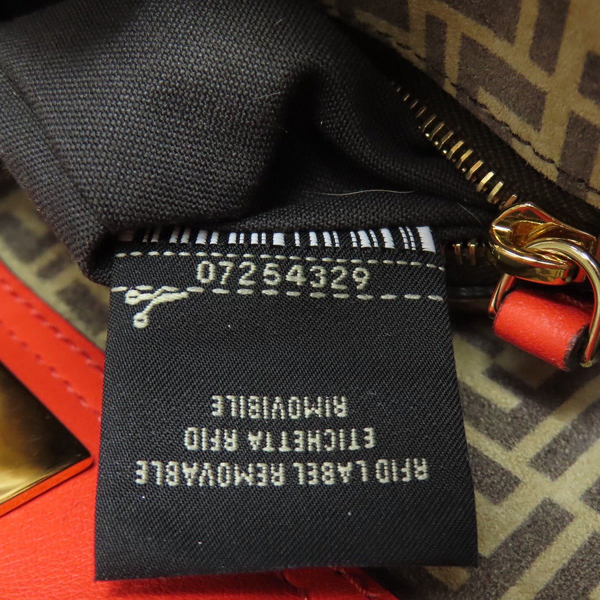 Close-up of a product tag on a red and black textured surface