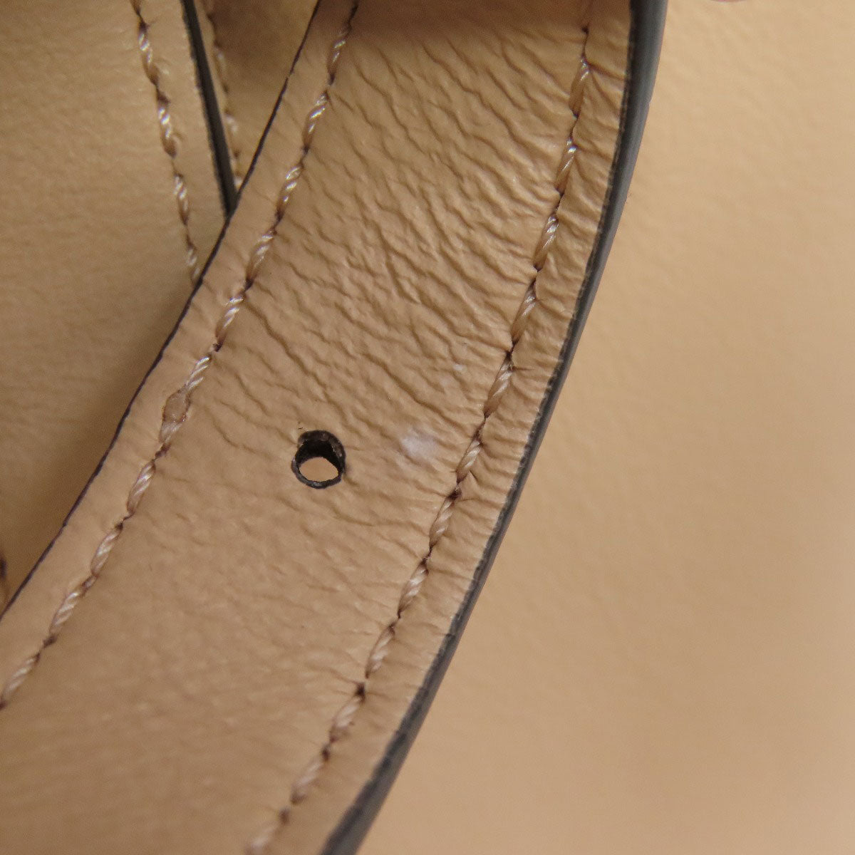 Close-up of beige leather with visible stitching