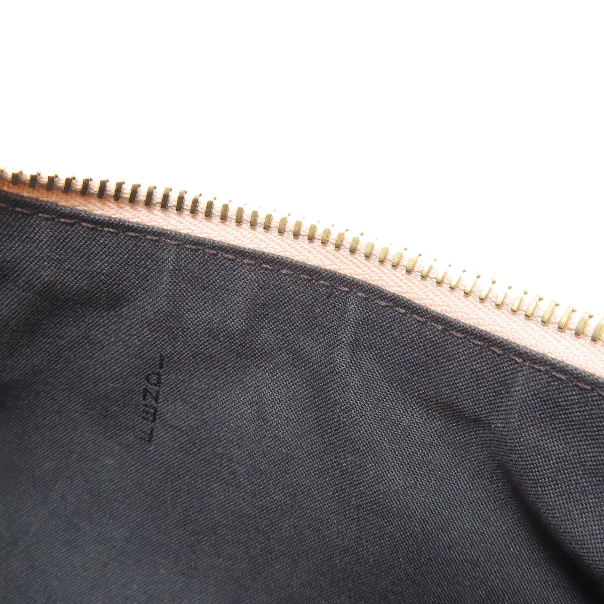 Close-up of a black pouch with a gold zipper and 'LOZZA' branding.