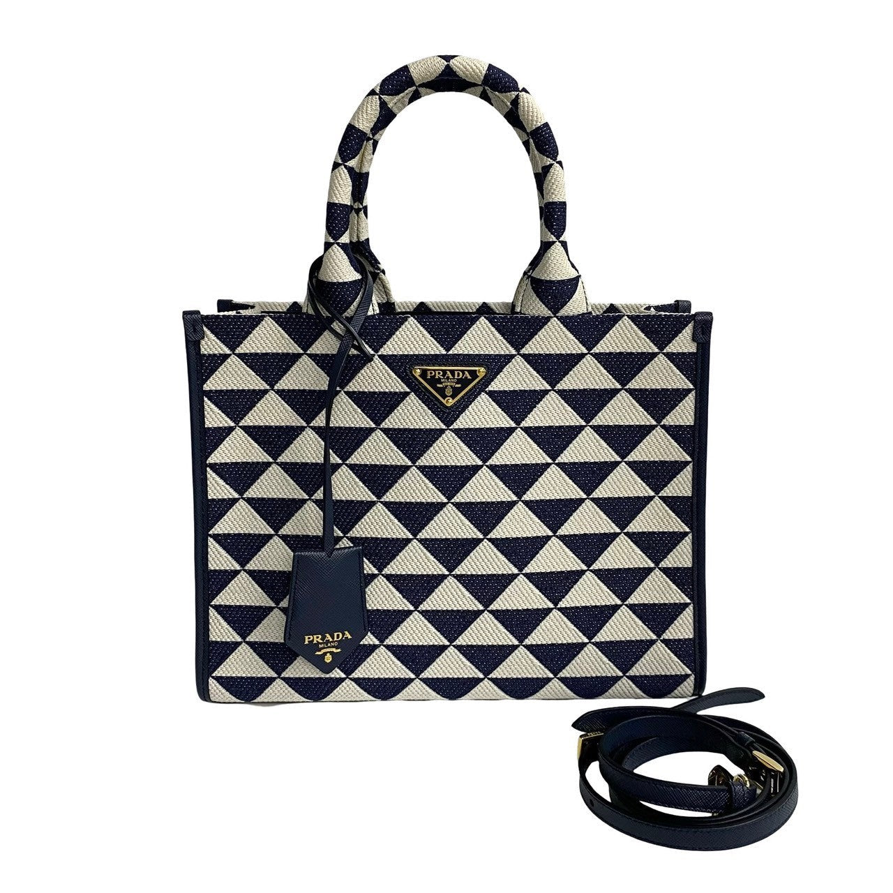 Prada handbag with navy and white geometric pattern on a white background