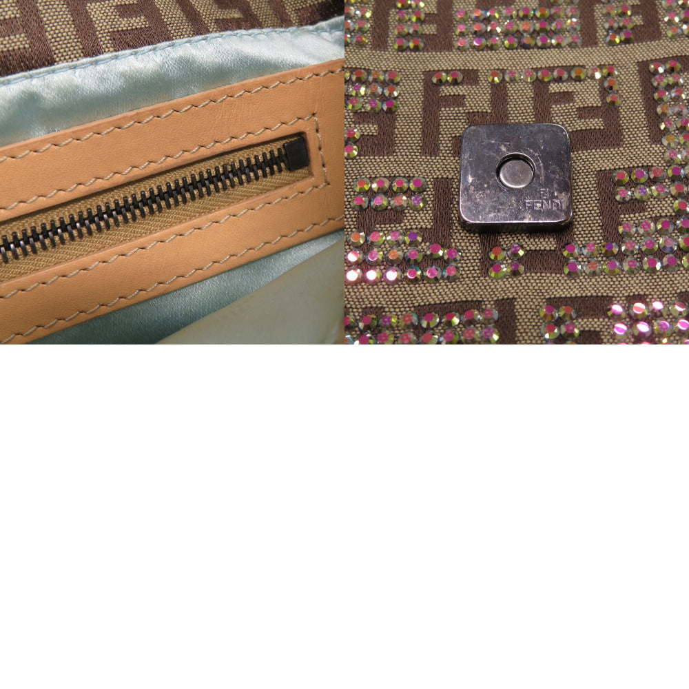 Close-up of a branded handbag with a zipper and decorative pattern.