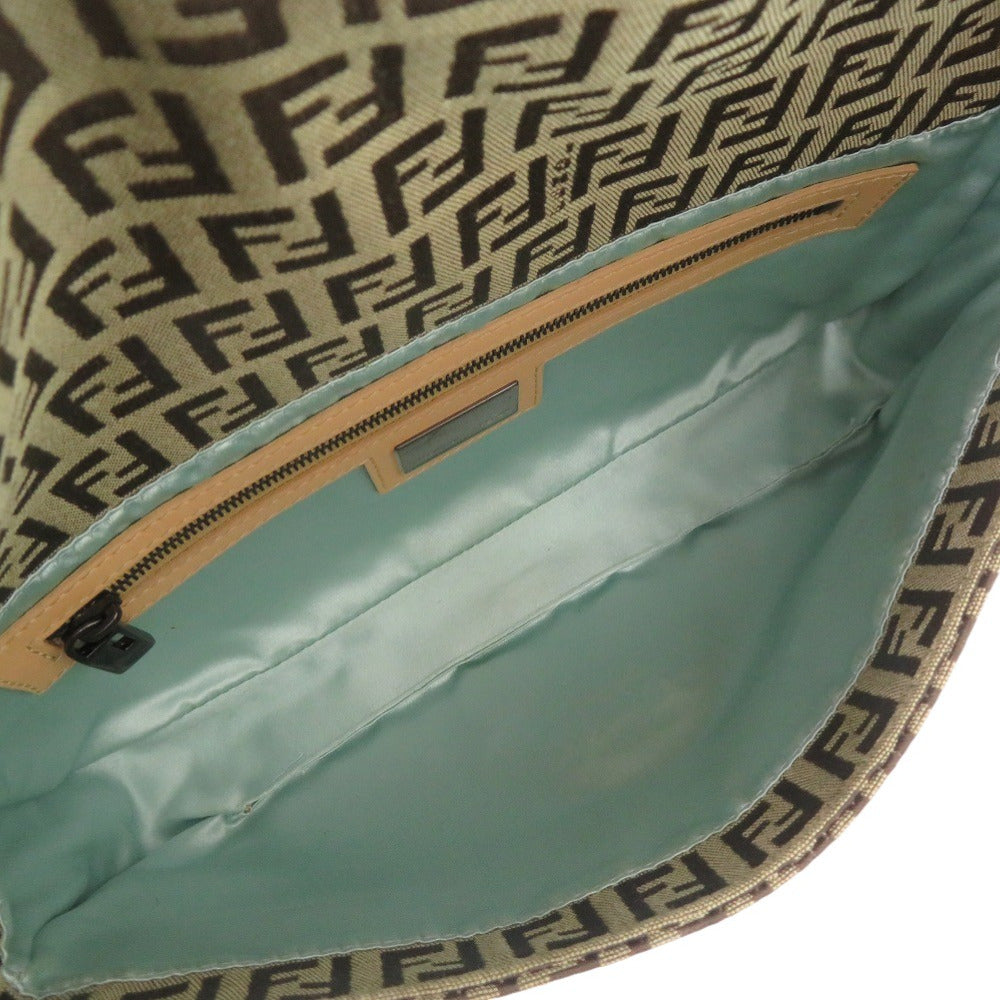 Close-up of a bag with a patterned edge and teal interior.