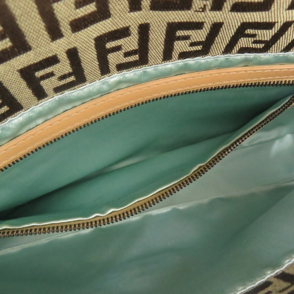 Close-up of a green fabric with a zipper and beige border, featuring a brand logo.